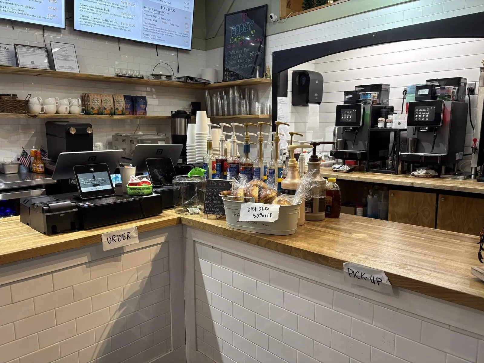 The Ellicottville Coffee counter with espresso machines, menu screens and the order and pick-up stations