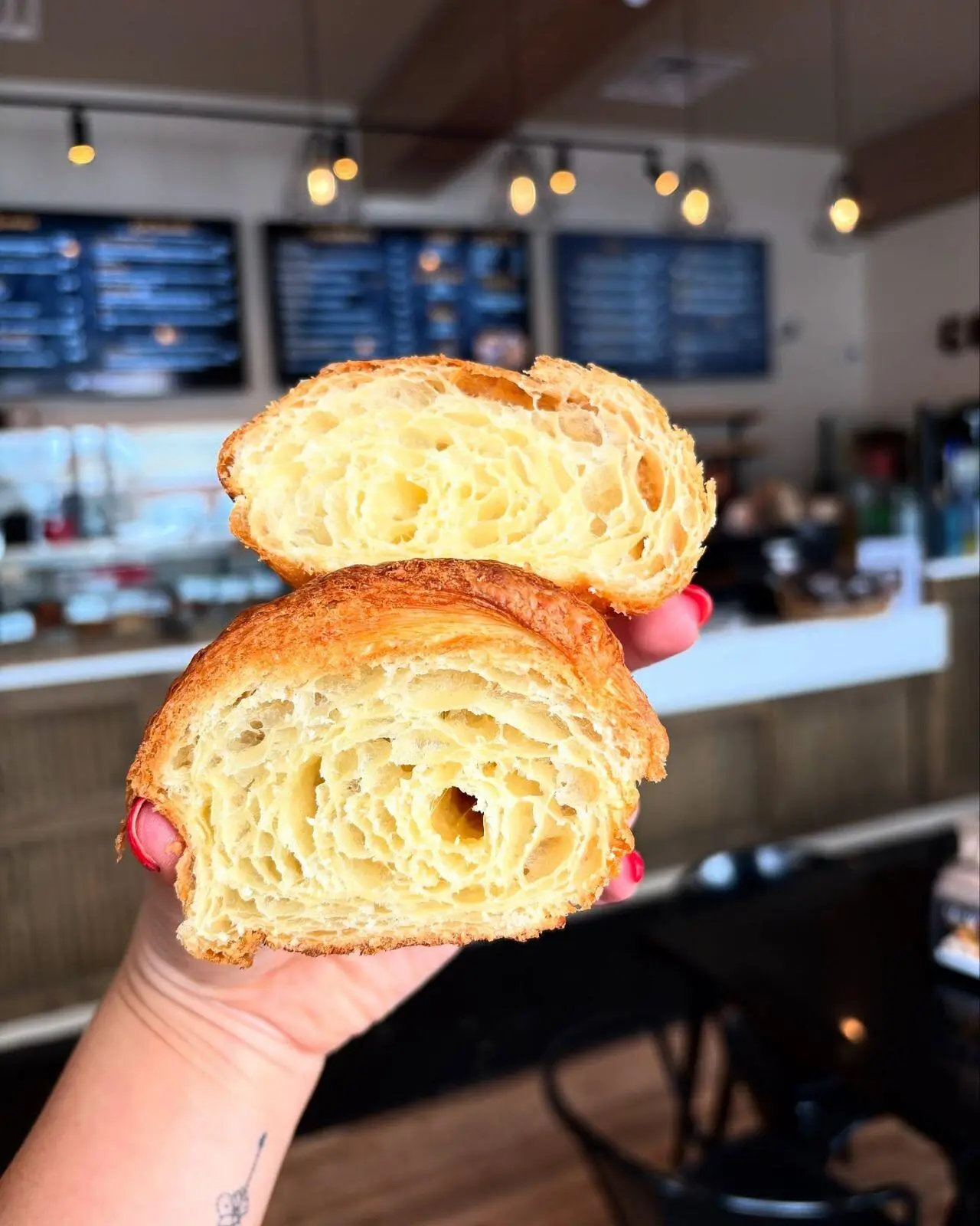 A flaky croissant pulled open at the Bake Shop counter
