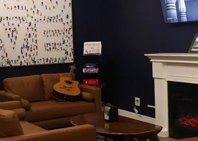 Lounge seating with leather armchairs and a fireplace