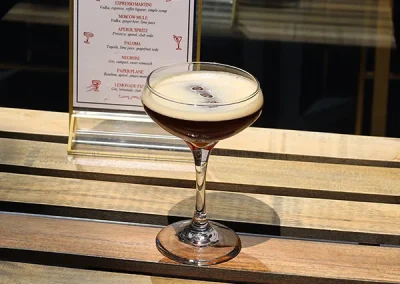 Espresso martini beside the printed cocktail menu
