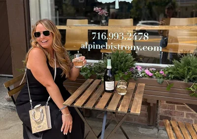 Guest seated at an outdoor table outside the Alpine Bistro front window